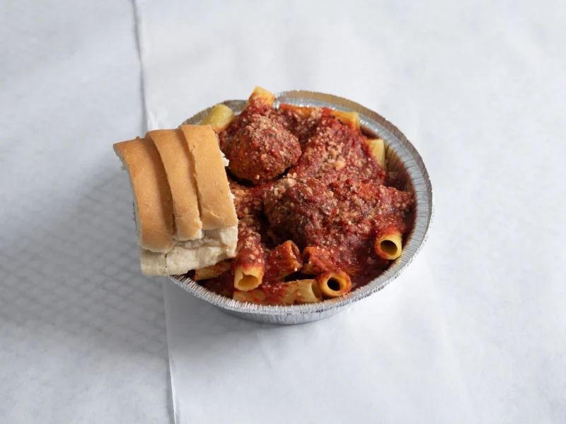 Pasta with homemade sauce, meatballs and fresh bread