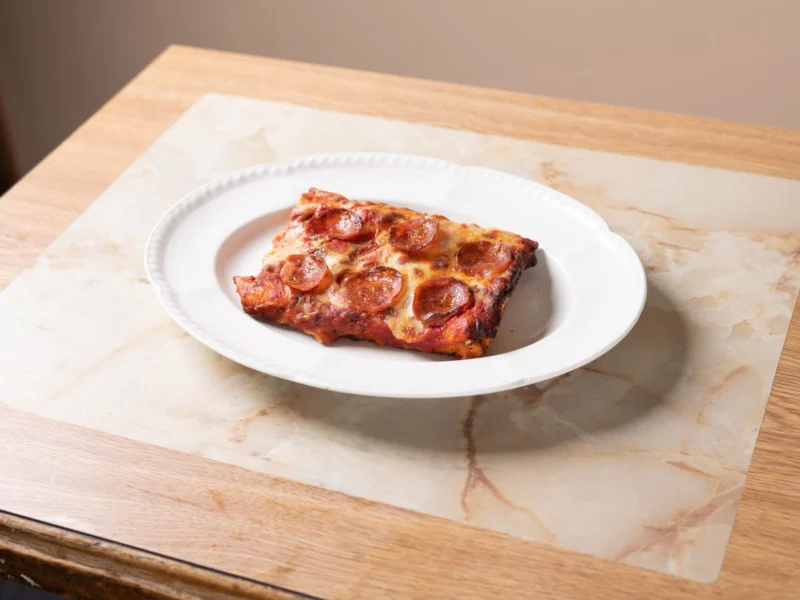 Square slice of pepperoni pizza