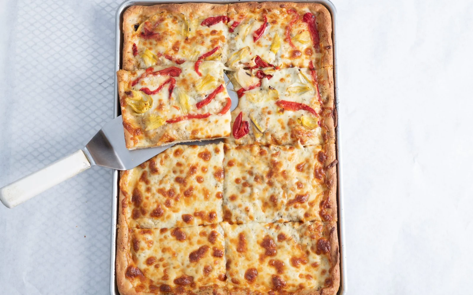 Sheet pizza cut into squares