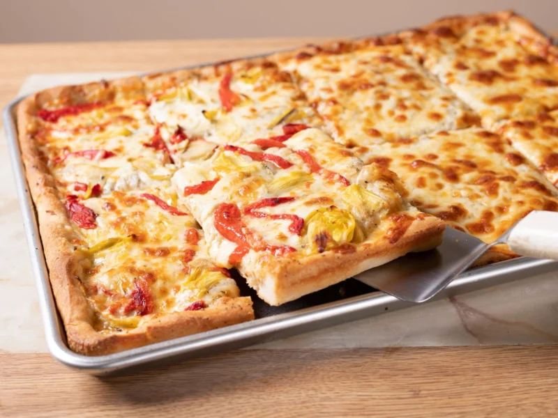 Sheet pizza with artichoke hearts and roasted red peppers